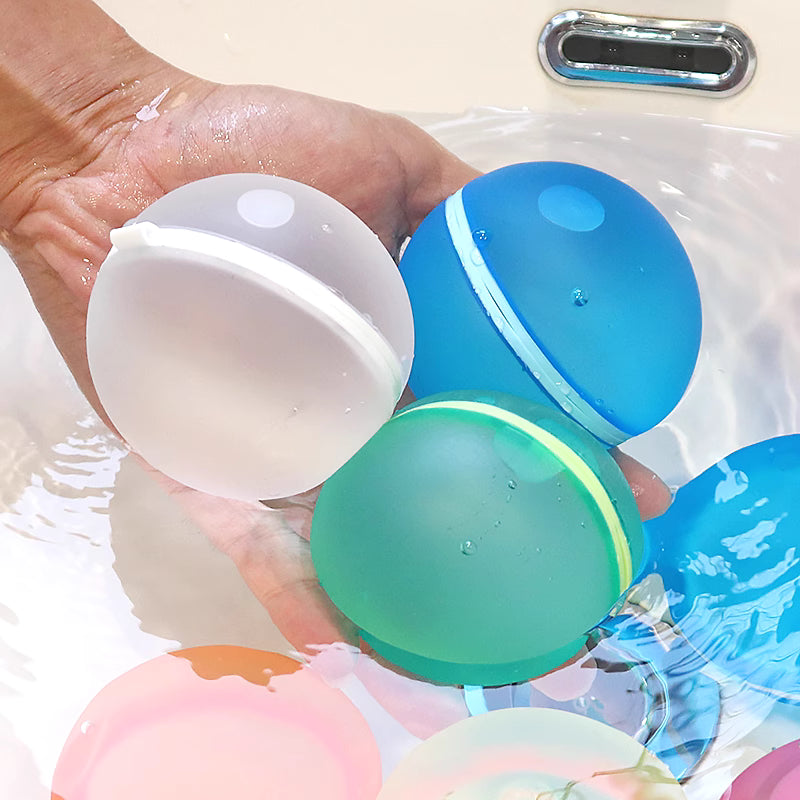 Colorful water balloons in a bathtub with a hand holding one.