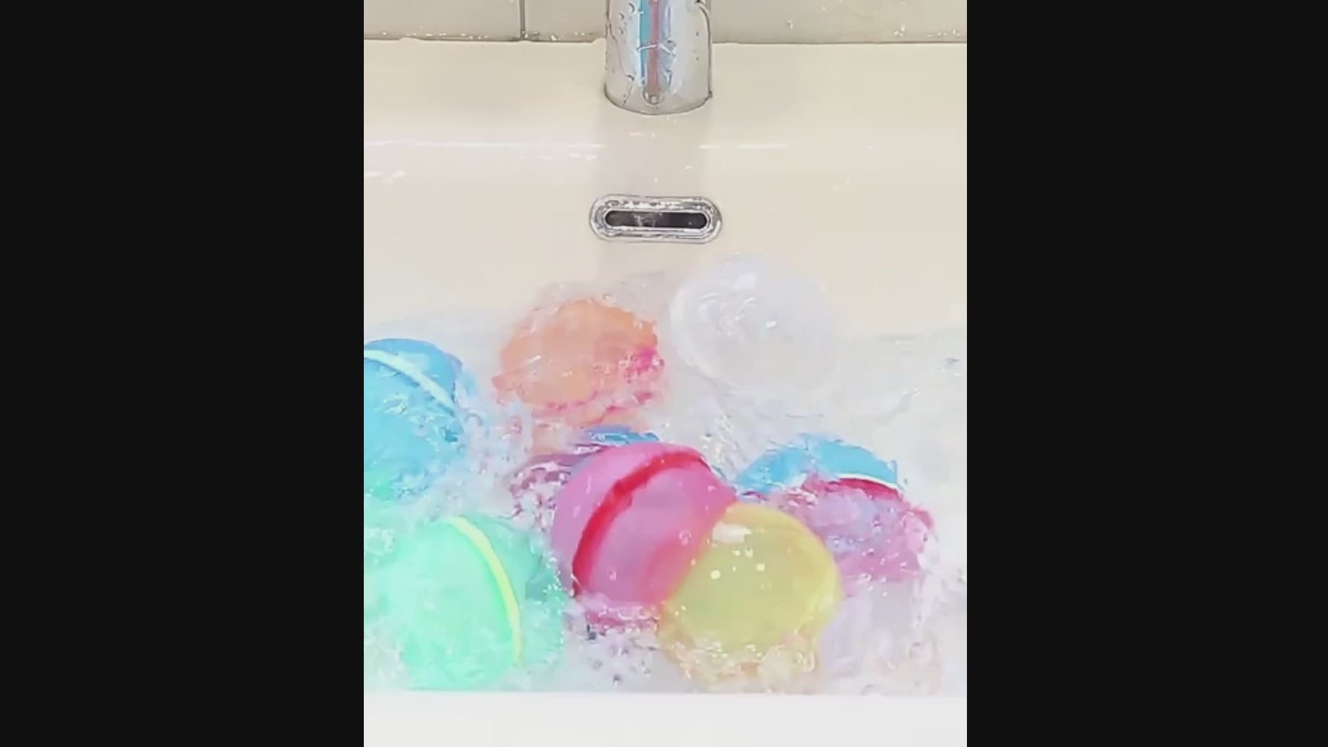 colorful silicone magnetic water balloons being filled with water and squeezed.